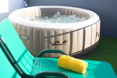 a hot tub with water in it on a green table at Casa Caromba, Sunset in Prazeres