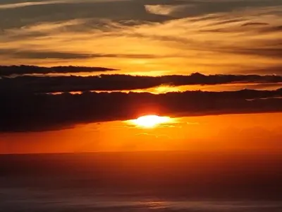a sunset over the ocean with clouds at Casa Caromba, Sunset in Prazeres