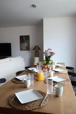 a long wooden table with plates and glasses on it at Heart of Funchal 4 BD Apartment - Casa d Alma in Funchal
