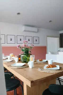 a table with pastries and a vase of flowers at Heart of Funchal 4 BD Apartment - Casa d Alma in Funchal