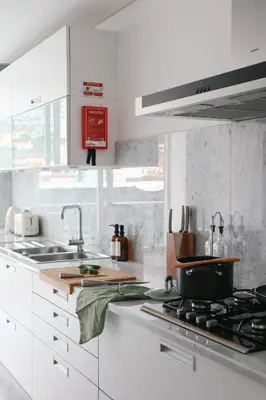 a kitchen with white cabinets and a pot on a stove at Heart of Funchal 4 BD Apartment - Casa d Alma in Funchal