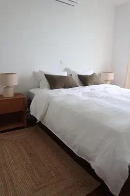 a bed with white sheets and pillows in a bedroom at Heart of Funchal 4 BD Apartment - Casa d Alma in Funchal