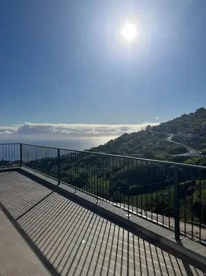 a view of the ocean from a balcony of a building at Sunset Valley House in Ribeira Brava