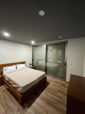 a bedroom with a bed and a large window at Sunset Valley House in Ribeira Brava