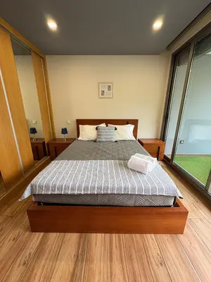 a bedroom with a bed and a large window at Sunset Valley House in Ribeira Brava