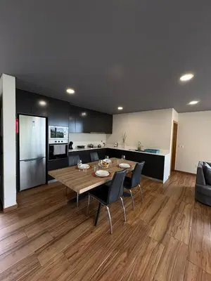 a kitchen and dining room with a table and chairs at Sunset Valley House in Ribeira Brava