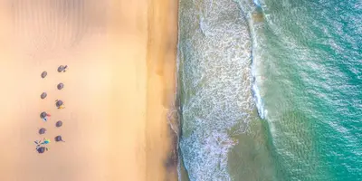an overhead view of people on a beach with the ocean at Casa do Ribeiro Salgado II by An Island Apart in Porto Santo