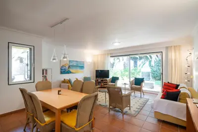 a living room with a table and a dining room at Casa do Ribeiro Salgado II by An Island Apart in Porto Santo