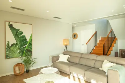a living room with a couch and a table at Villa Eden Nature in Prazeres in Prazeres