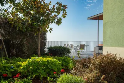 a garden with flowers in front of a building at Villa Eden Nature in Prazeres in Prazeres