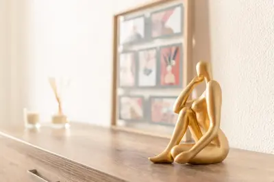 a wooden figurine of two people sitting on a table at Casa das Rosas in Funchal