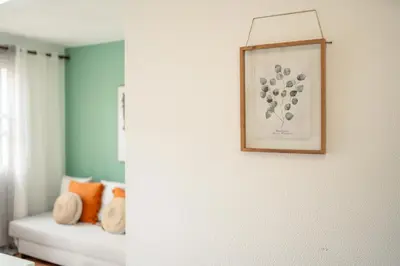 a room with a couch and a picture on a wall at Casa das Rosas in Funchal