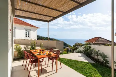 a house on a hill with a swimming pool at MemorHia Village by OurMadeira in Calheta