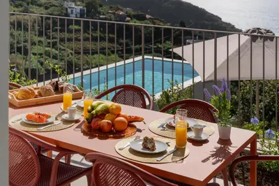 a bedroom with a bed with a towel on it at MemorHia Village by OurMadeira in Calheta