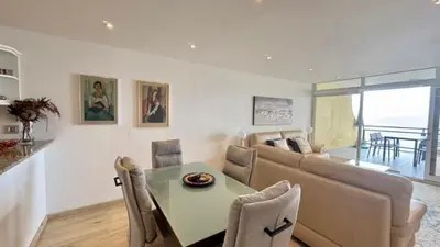 a living room with a table and a couch at Sea Haven in Funchal