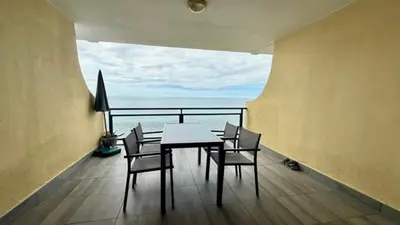 a table and chairs in a room with a view of the ocean at Sea Haven in Funchal