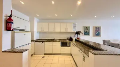 a kitchen with white cabinets and a counter top at Sea Haven in Funchal