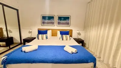 a bedroom with a large bed with blue sheets and pillows at Sea Haven in Funchal