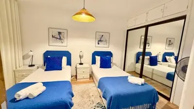two beds in a room with blue and white at Sea Haven in Funchal