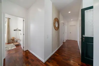 a hallway with white walls and a black door at Casa do Beiral by An Island Apart in Santa Cruz
