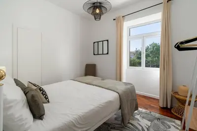 a bedroom with a bed and a window at Casa do Beiral by An Island Apart in Santa Cruz