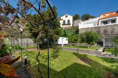 a garden with a fire hydrant in the grass at Casa do Beiral by An Island Apart in Santa Cruz