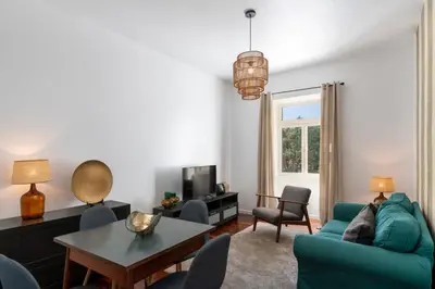 a living room with a blue couch and a table at Casa do Beiral by An Island Apart in Santa Cruz