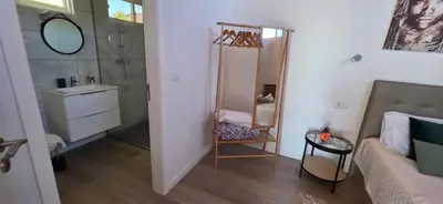 a bathroom with a toilet and a sink and a window at Chalet Abacates in Estreito da Calheta