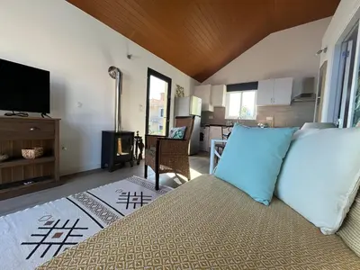 a bedroom with a bed and a mirror at Chalet Abacates in Estreito da Calheta