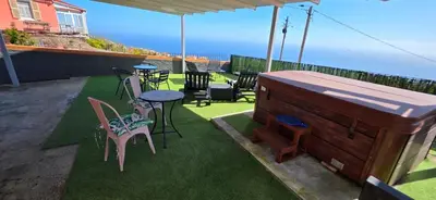 a large pool of water in a yard with a fence at Chalet Abacates in Estreito da Calheta