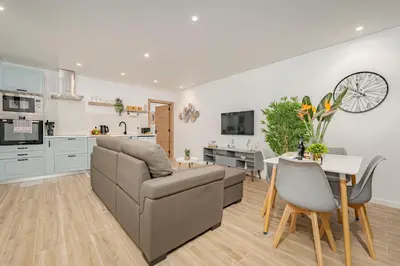 a kitchen and living room with a couch and a table at Oxford apartment Alpine escape villa in Gaula