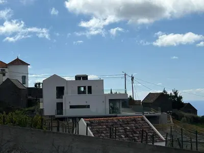 a white house on top of a building at Villa MARIE in Fajã da Ovelha
