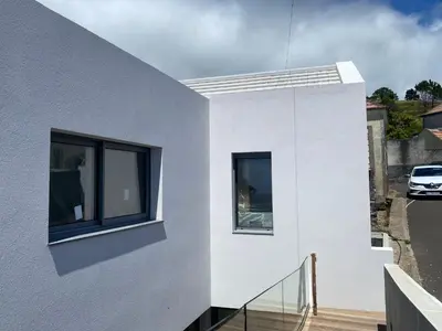 a white house with windows and a balcony at Villa MARIE in Fajã da Ovelha