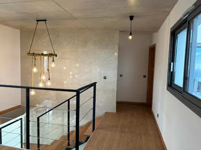 a staircase in a room with a window at Villa MARIE in Fajã da Ovelha
