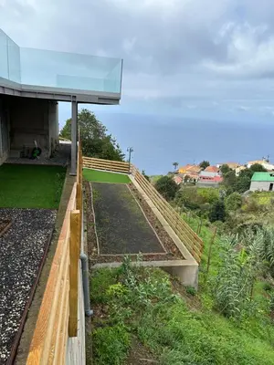 a view of a garden with a building at Villa MARIE in Fajã da Ovelha