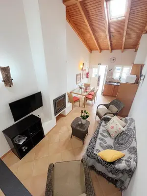 a living room with a couch and a fireplace at Casa Roma in Raposeira