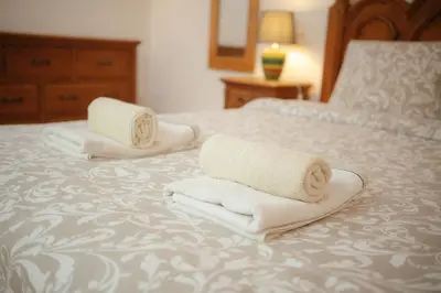 two towels sitting on top of a bed at Casa Roma in Raposeira