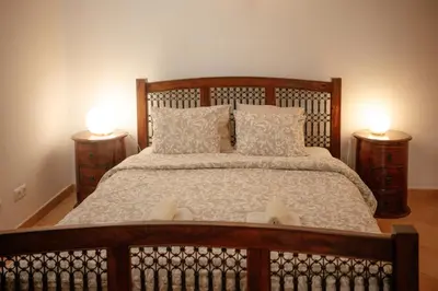 a bedroom with a large bed with two lamps at Casa Roma in Raposeira
