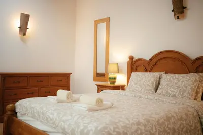 a bedroom with a bed with two towels on it at Casa Roma in Raposeira