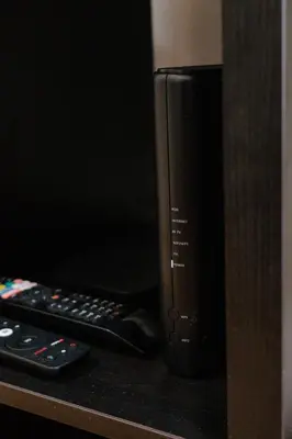 two remote controls sitting on a counter next to a microwave at Casa Roma in Raposeira