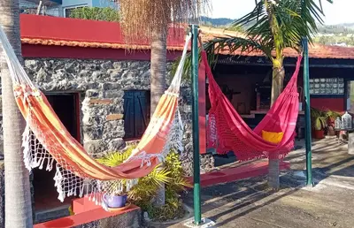 two hammocks hanging in front of a building at Refugio Jardim Prazeres WiFi BBQ in Prazeres