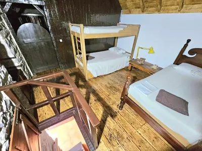 a room with two bunk beds in a house at Refugio Jardim Prazeres WiFi BBQ in Prazeres