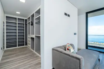 a walk in closet with a couch and a window at Villa Lunarenzo seaview, Pool, AC, parking in Calheta