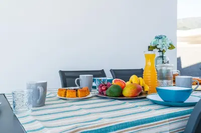 a table with a plate of fruit on it at Villa Lunarenzo seaview, Pool, AC, parking in Calheta
