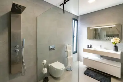 a bathroom with a shower and a toilet and a sink at Villa Lunarenzo seaview, Pool, AC, parking in Calheta