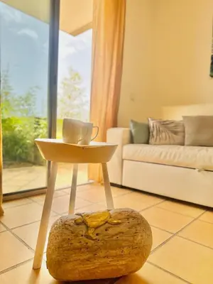 a table with a cup of coffee on it in a living room at Casa Bamboo in Porto Santo