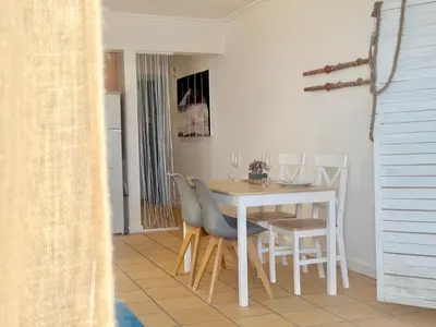 a dining room with a white table and chairs at Casa Bamboo in Porto Santo