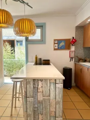a kitchen with a island in the middle of a room at Casa Bamboo in Porto Santo