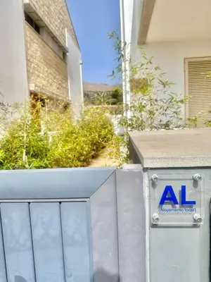 a sign on a wall in front of a building at Casa Bamboo in Porto Santo