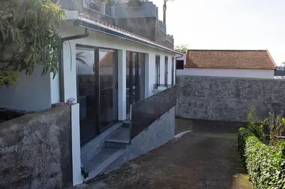 a house with glass doors on the side of it at Atlantic View Residence in Funchal